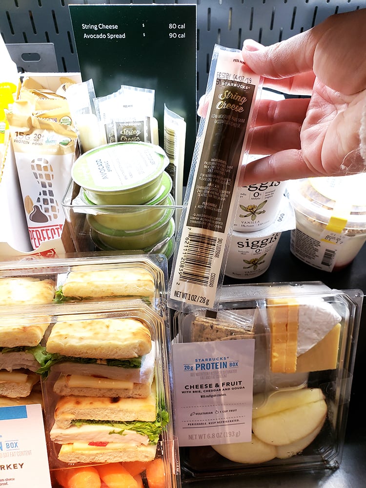 picking up string cheese from cold case at starbucks