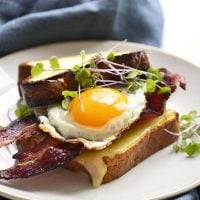 keto breakfast sandwich on a white plate with a blue napkin