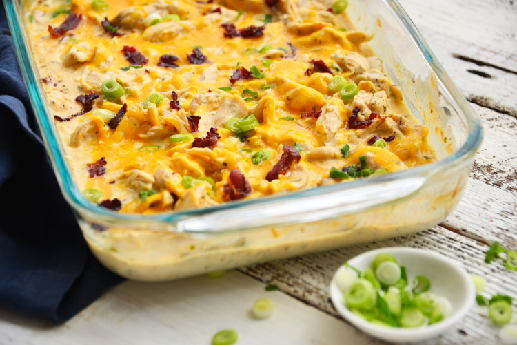 baked crack chicken and a side dish of green scallions