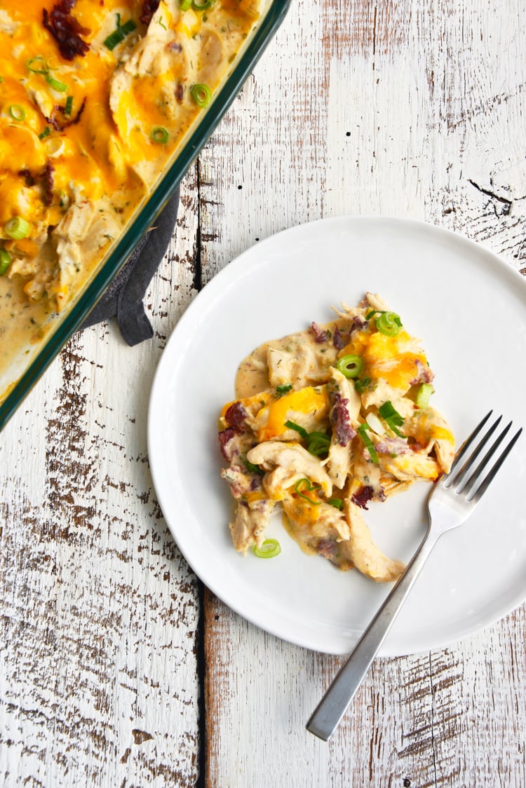 baked crack chicken served on a white plate with a fork on top