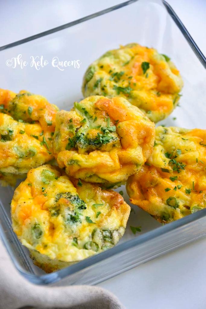 vertical image of broccoli and cheddar egg muffins in a glass storage container