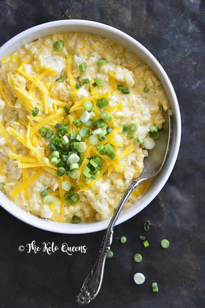 keto mac and cheese recipe in a white bowl topped with scallions 