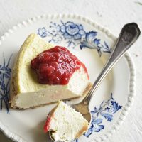 low carb instant pot cheese cake with easy strawberry sauce on a white background