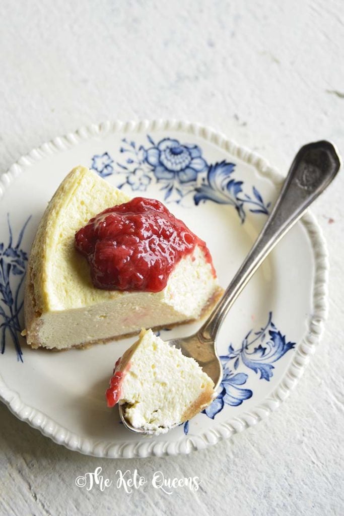 low carb instant pot cheese cake with easy strawberry sauce on a white background