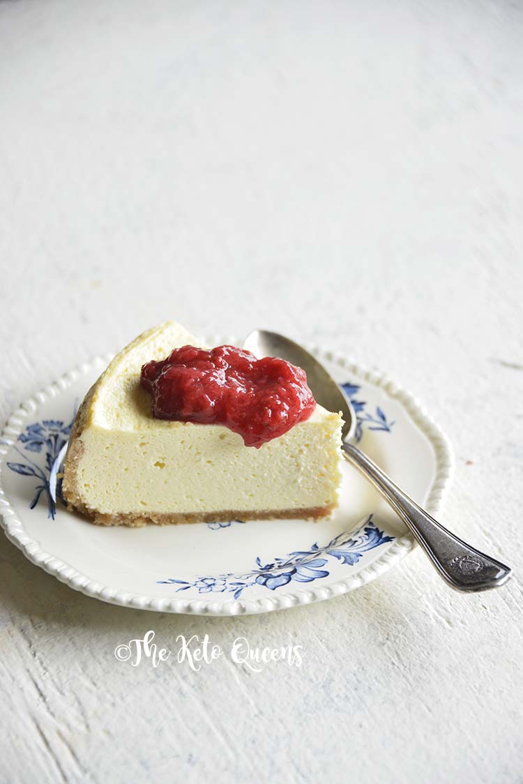 low carb instant pot cheese cake with easy strawberry sauce on a white background