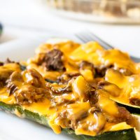 slow cooker BBQ brisket stuffed zucchini boats on a white plate