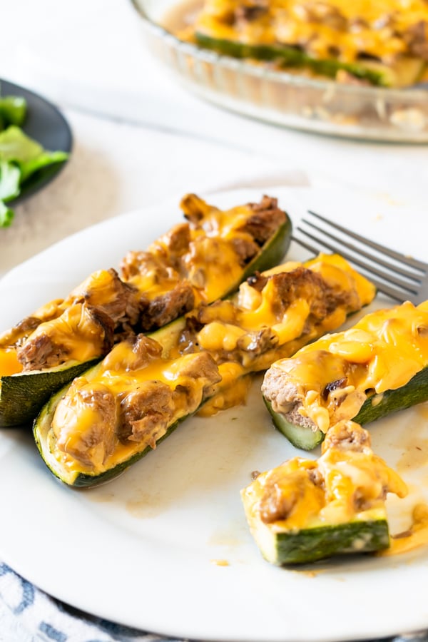 slow cooker BBQ brisket stuffed zucchini boats on a white plate