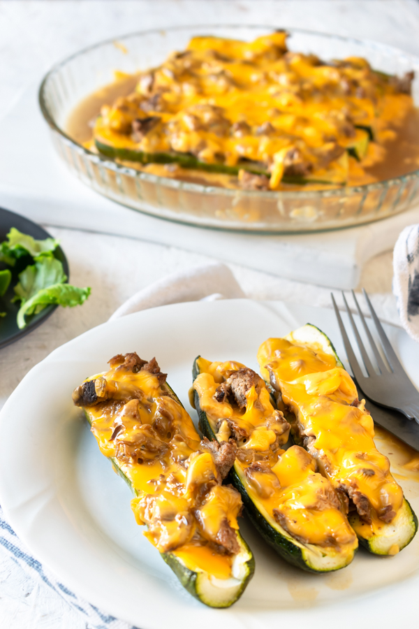 slow cooker BBQ brisket stuffed zucchini boats on a white plate