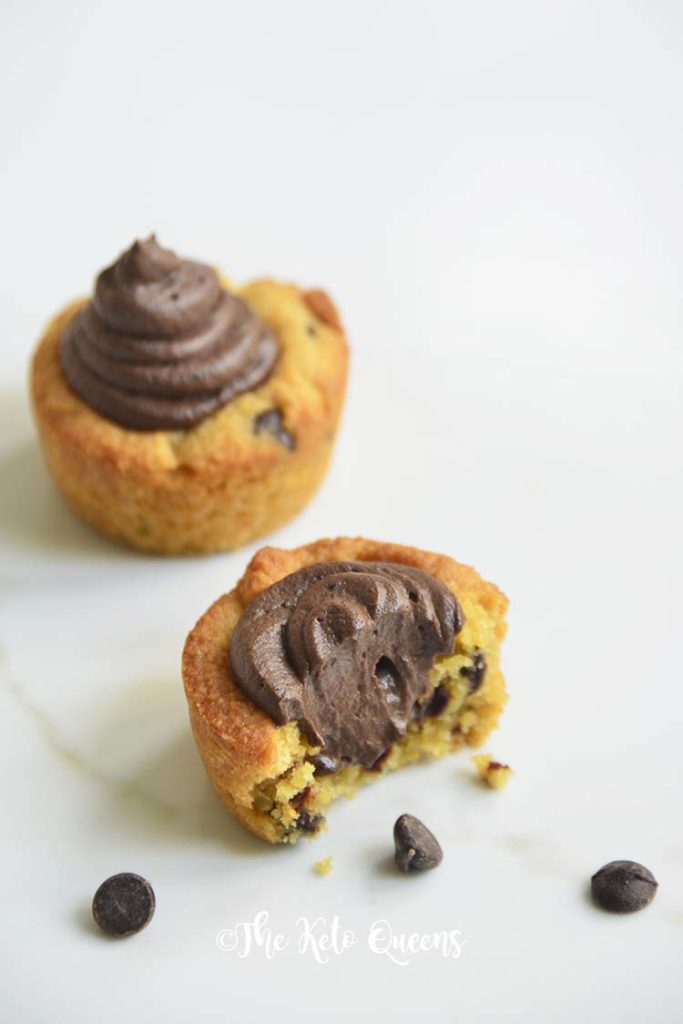 2 Chocolate Chip Cookie Cups with Chocolate Buttercream frosting and 1 with a bite taken out