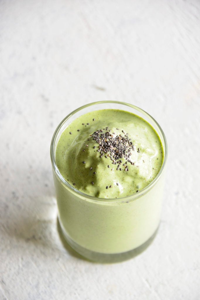 Keto Protein Green Smoothie in a clear glass with chia seeds on top