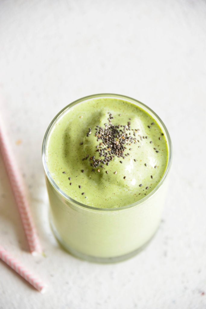Keto Protein Green Smoothie in a clear glass with chia seeds on top