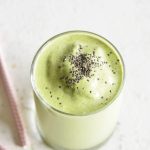 Keto Protein Green Smoothie in a clear glass with chia seeds on top