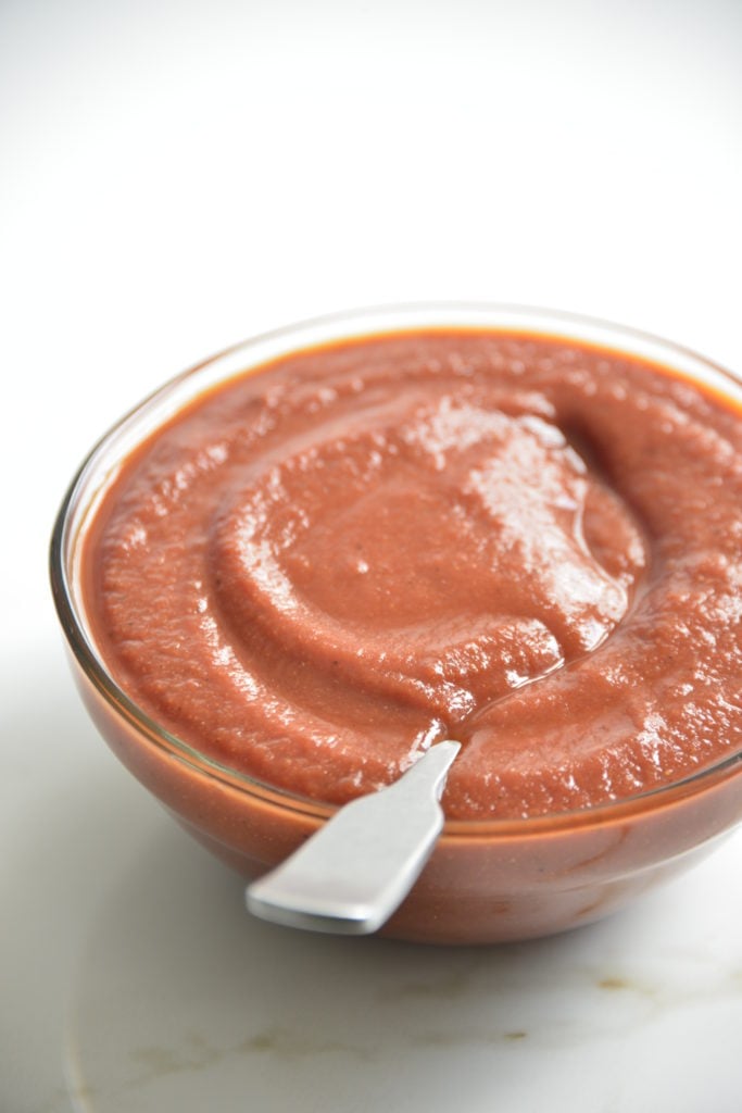 bowl of sugar free BBQ sauce i a clear bowl with a spoon