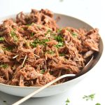 keto bbq pulled pork on a white bowl with parsley