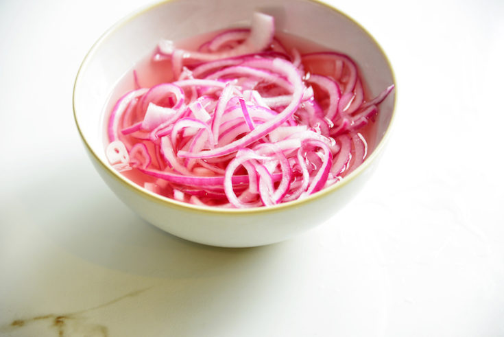 pickled red onions made without sugar in a white bowl