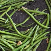 green beans cooked in a cast iron skillet with garlic
