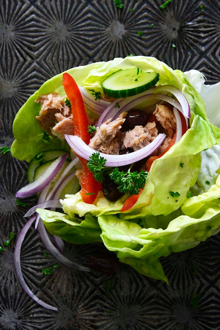 close up image of Mediterranean Tuna Lettuce Wraps on a dark background