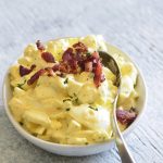 image of keto egg salad with bacon and a spoon on top