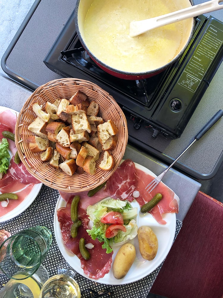 Fondue Spread with Charcuterie, Vegetables, and Bread Cubes