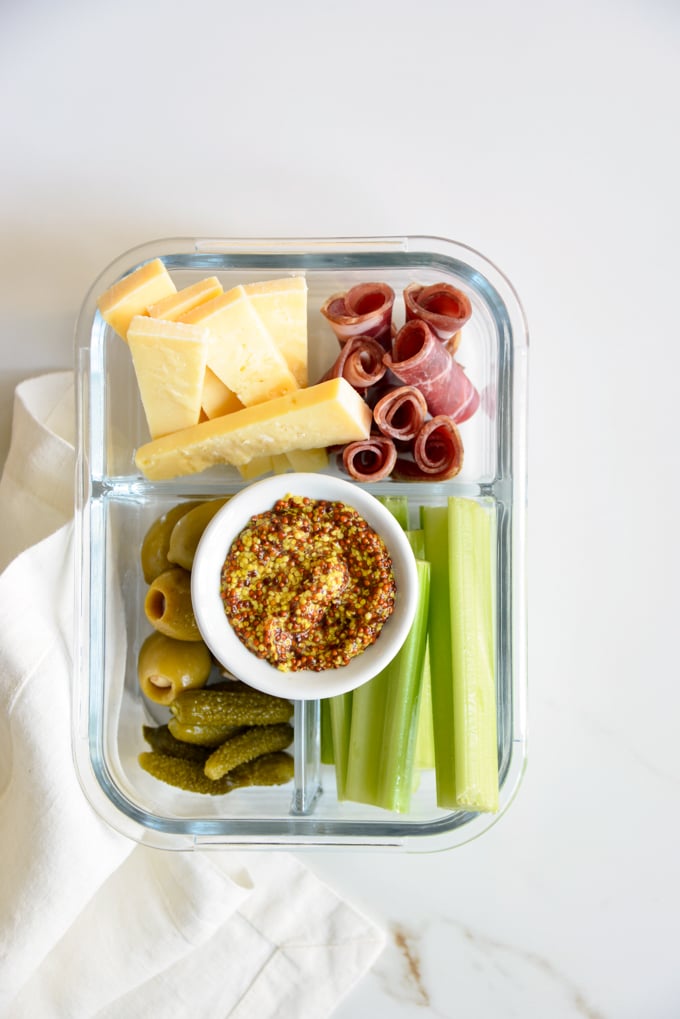 Charcuterie and cheese is a quick and easy keto meal prep idea! Pack some charcuterie meats, cheese, pickles, olives, and celery in your favorite meal prep container. It'll make for a delicious, grab and grow lunch.