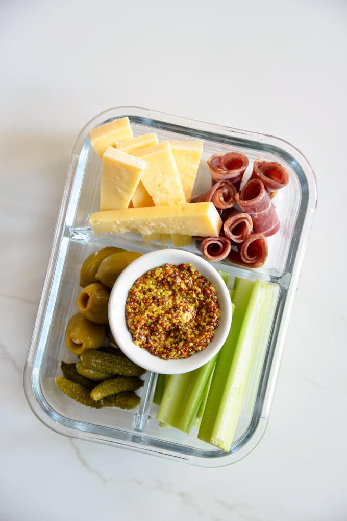 Charcuterie and cheese is a quick and easy keto meal prep idea! Pack some charcuterie meats, cheese, pickles, olives, and celery in your favorite meal prep container. It'll make for a delicious, grab and grow lunch.