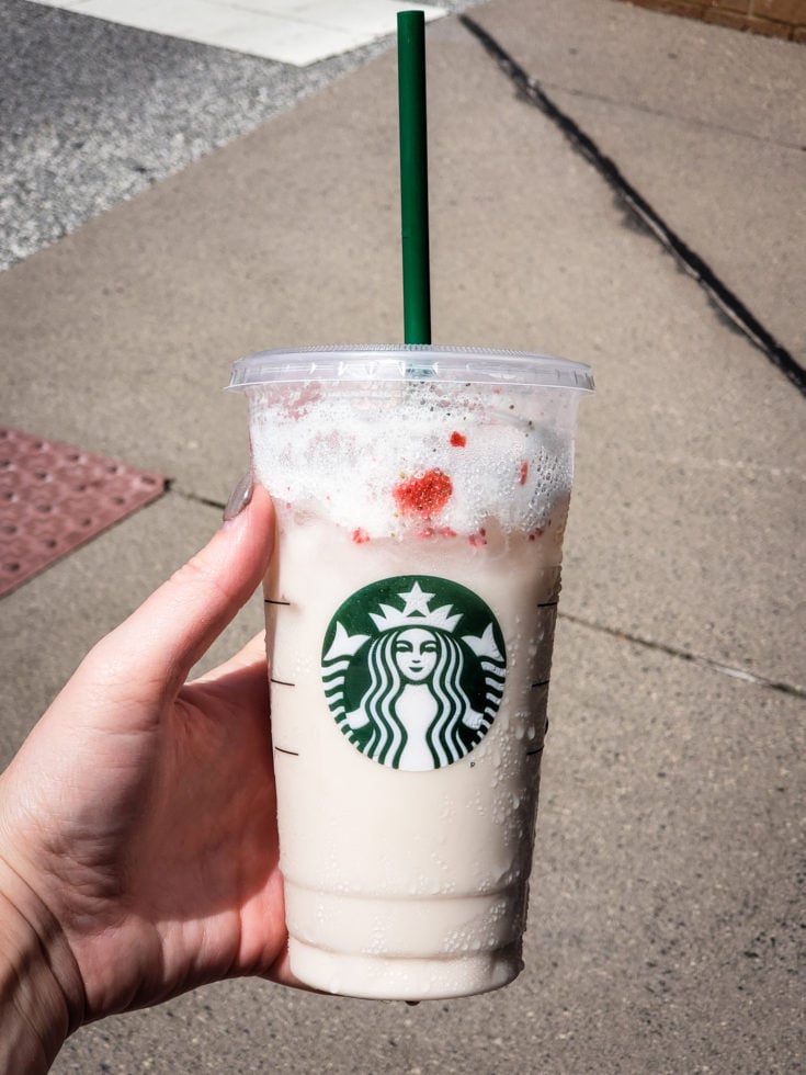 Tired of boring black coffee? Check out my top 5 Keto Starbucks Drinks to brighten your morning. image of a person holding a keto pink drink