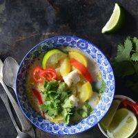 image of a bowl of thai coconut curry with red bell peppers and yellow squash.