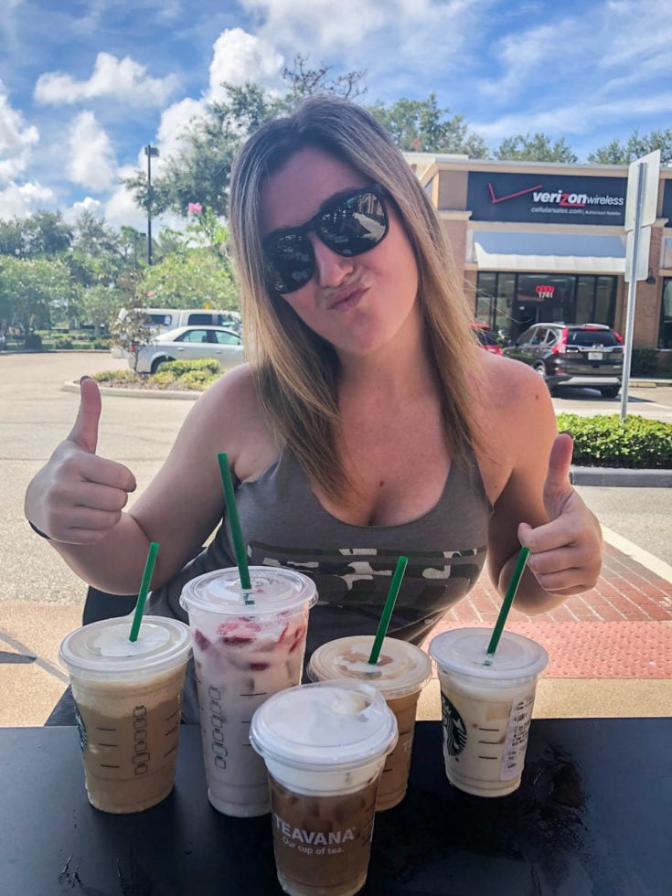 girl with 5 keto starbucks drinks on a table outside