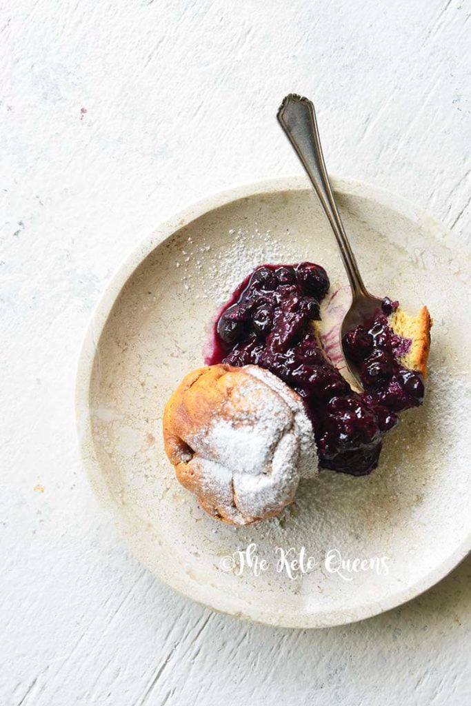vertical image of Low Carb Brioche Bread with low carb blueberry sauce with a spoon