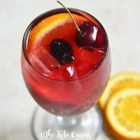 keto sangria mocktail recipe in a clear glass garnished with cherries and orange slices