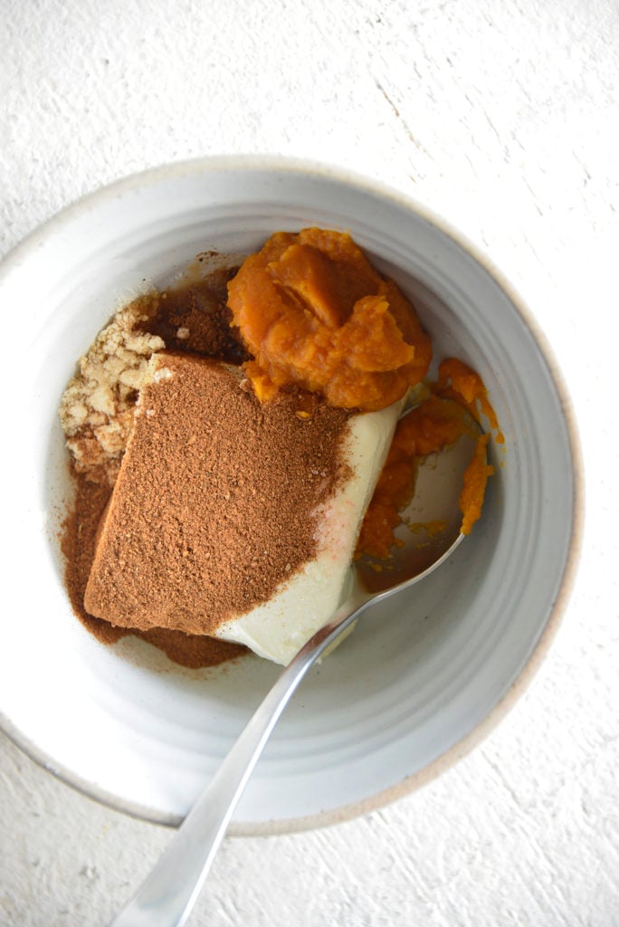 Keto Pumpkin Spice Cream Cheese Fat Bombs ingredients in a white bowl ingredients in a white bowl