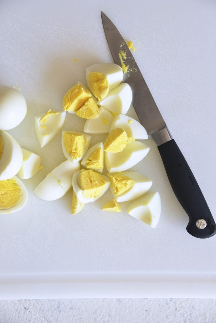 sliced hard boiled egg next to a knife