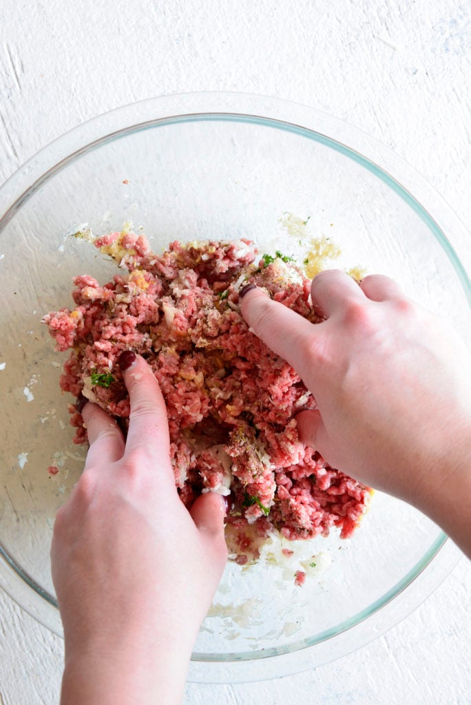classic pressure cooker meatloaf recipe ingredients in a clear bowl being mixed