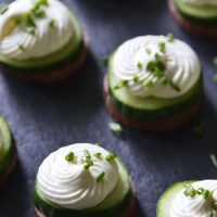 Summer Sausage Cucumber Bites with Cream Cheese Mousse and Fresh Chives on Slate Board