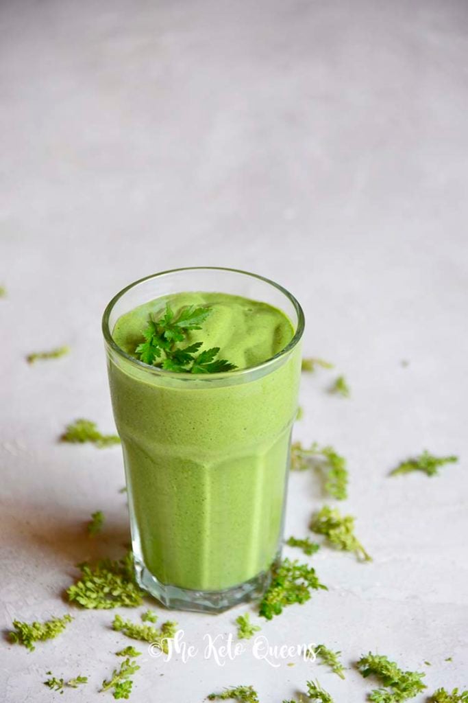 detox keto green smoothie in a clear cup with parsley on top