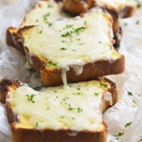 low carb Texas toast on a parchment paper topped with parsley