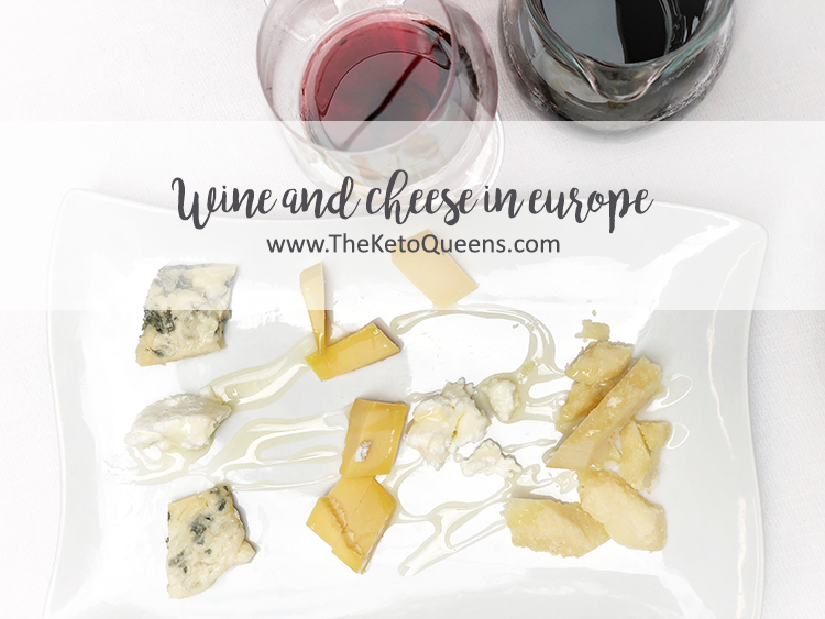 Wine and Cheese in Europe with a Selection of Cheese on a White Tray Next to a Glass of Red Wine
