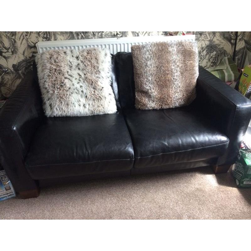 Black leather two seater sofa