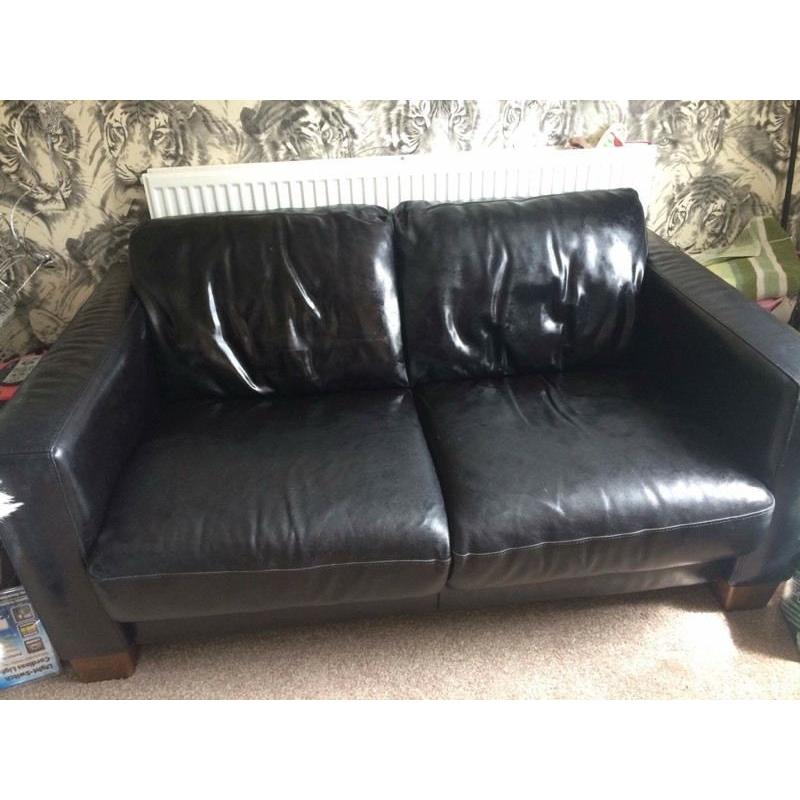 Black leather two seater sofa