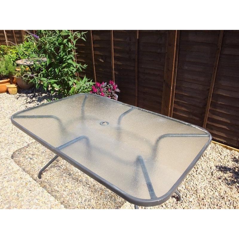 Garden table 2 years old. Oblong, glass top, seats 6.