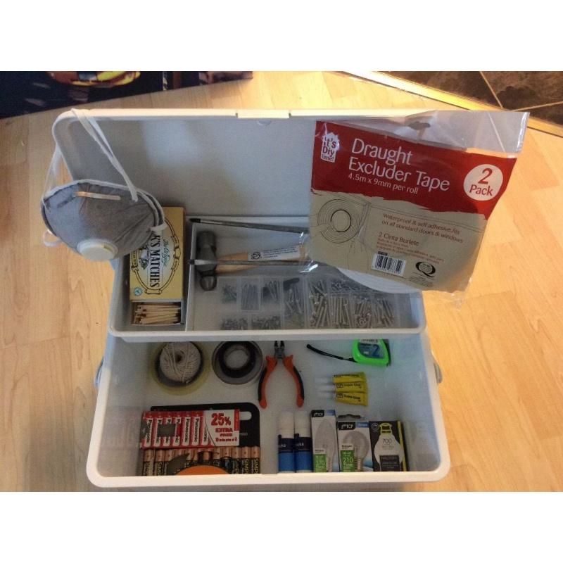Tool box with several tools and items: 2 screwdrivers, hammer, assorted screws, batteries, etc.