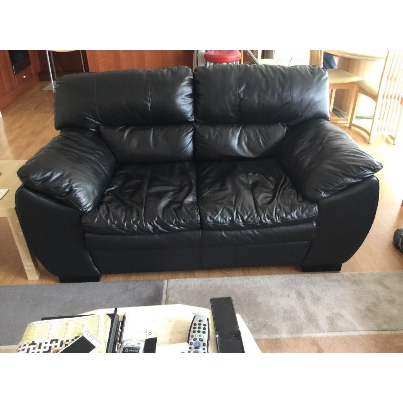 Two black leather sofas three seater and two seater good condition.