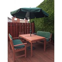 Garden dining table, two benches, two chairs and parasol with base